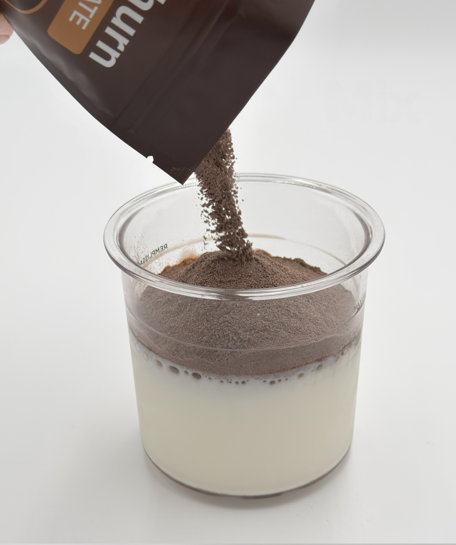 Pouring NutraChurn mix into milk